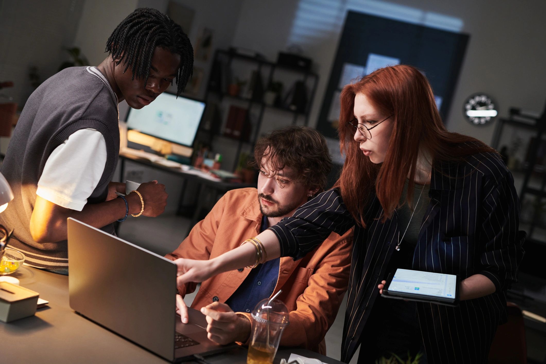 Team members reviewing performance data on a laptop